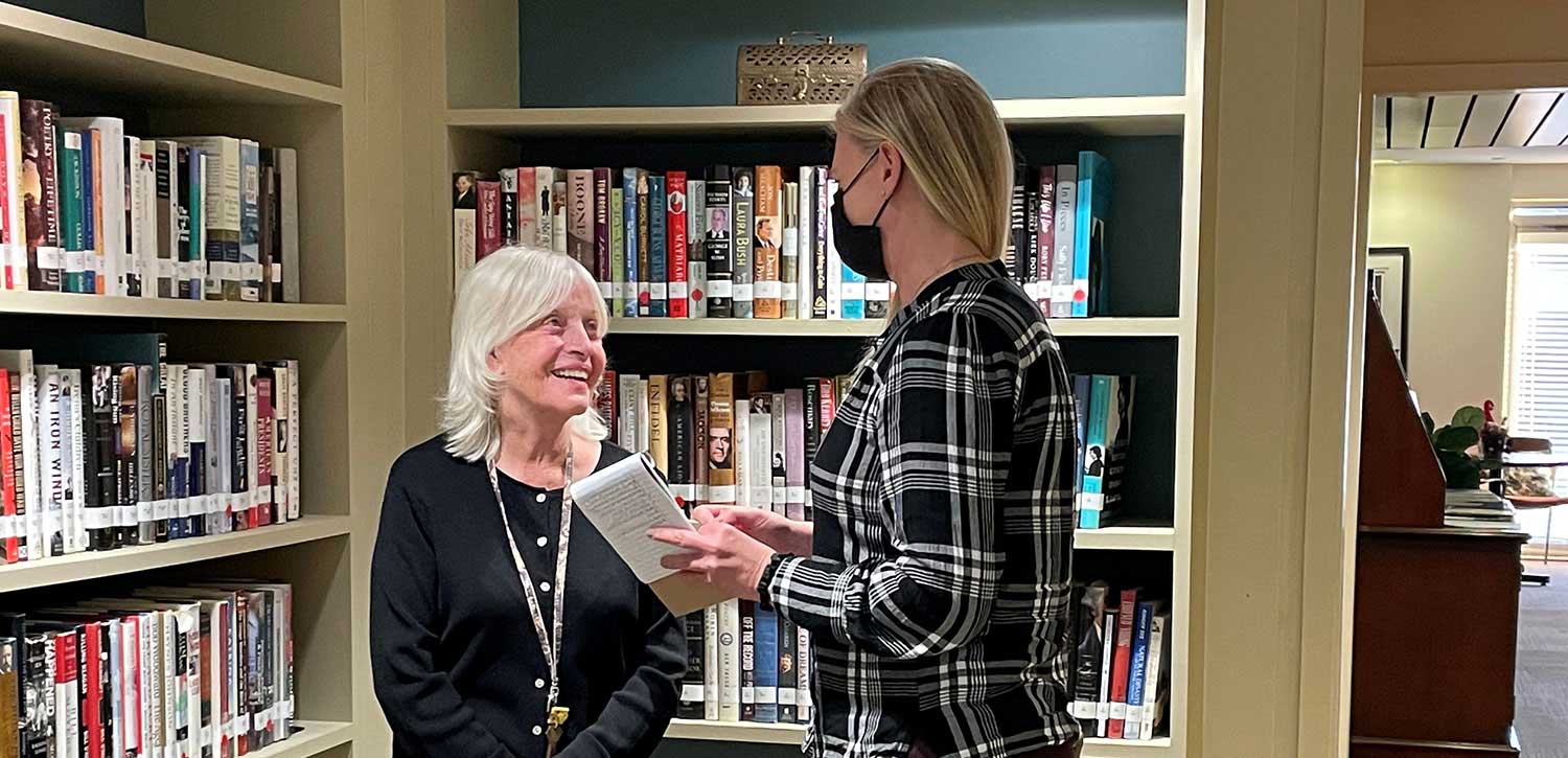 Judy Simmons in Library at Abe's Garden Community