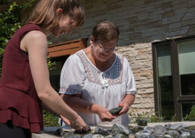 Memory Care resident working in rock garden at Abe's Garden Community