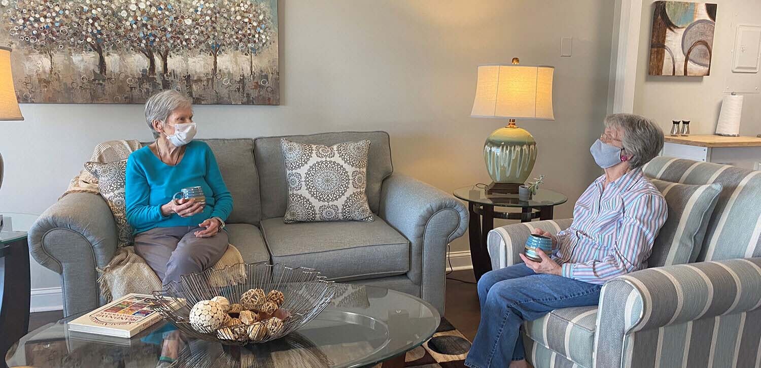 Two Independent Living Residents sitting on couches and talking