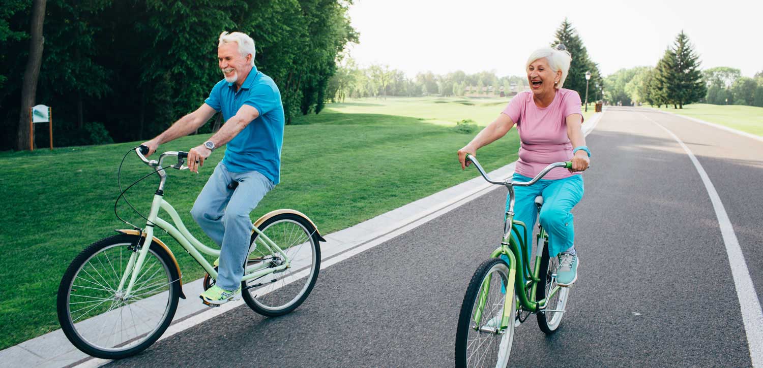 Two seniors riding their bikes