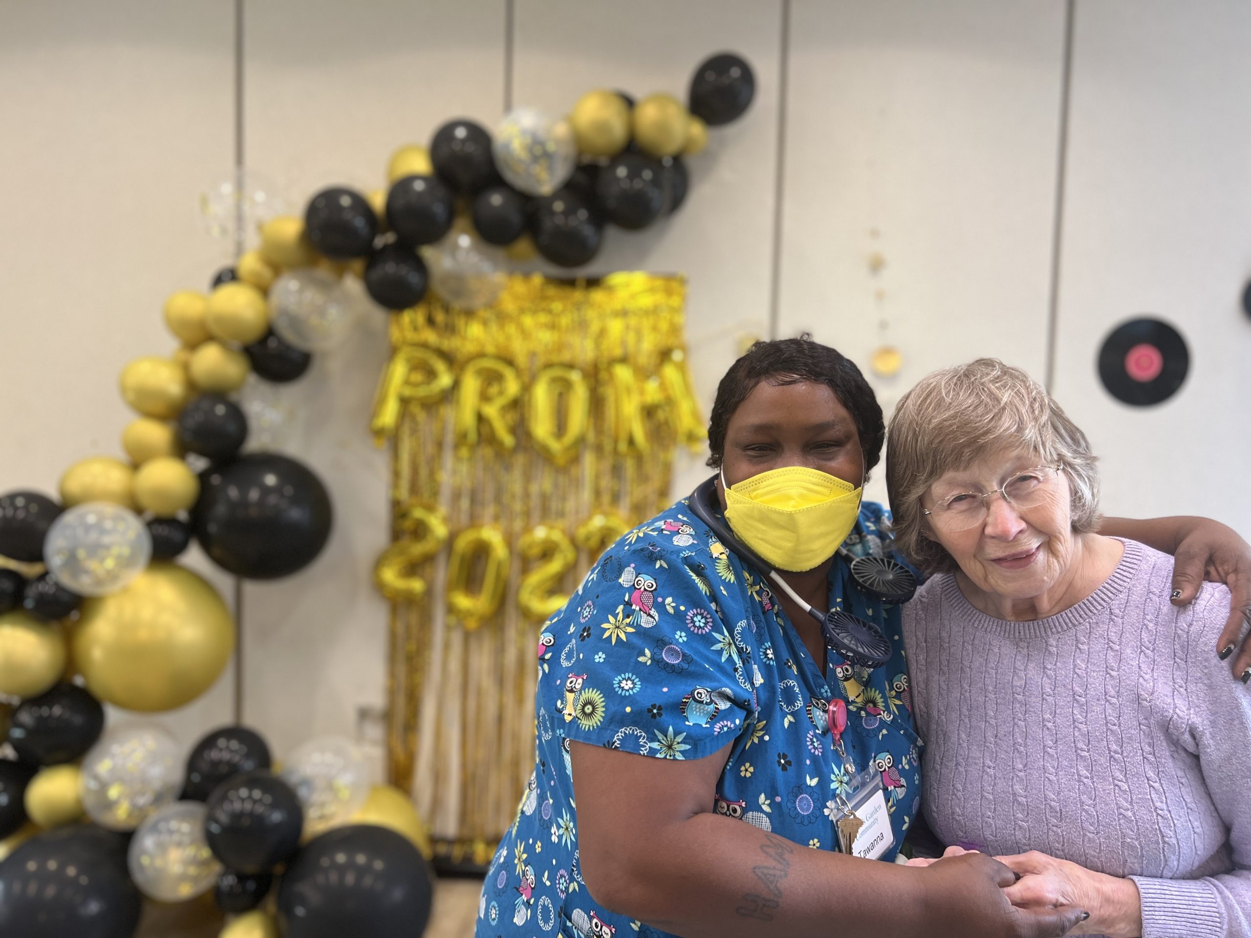 Happy and Curley Caregiver and Abe's Garden Memory Care resident at Senior Living Prom 2022