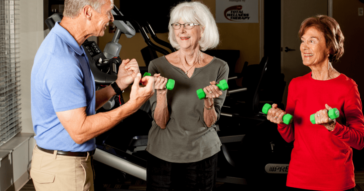 Two elder women working out in the senior living communities ammenities.